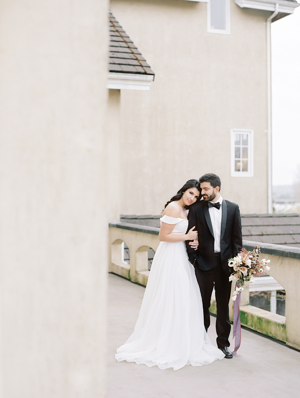 Chateau-Lill-Wedding-Balcony-Couple.jpg A couple leaning on each other on the balcony of Chateau Lill