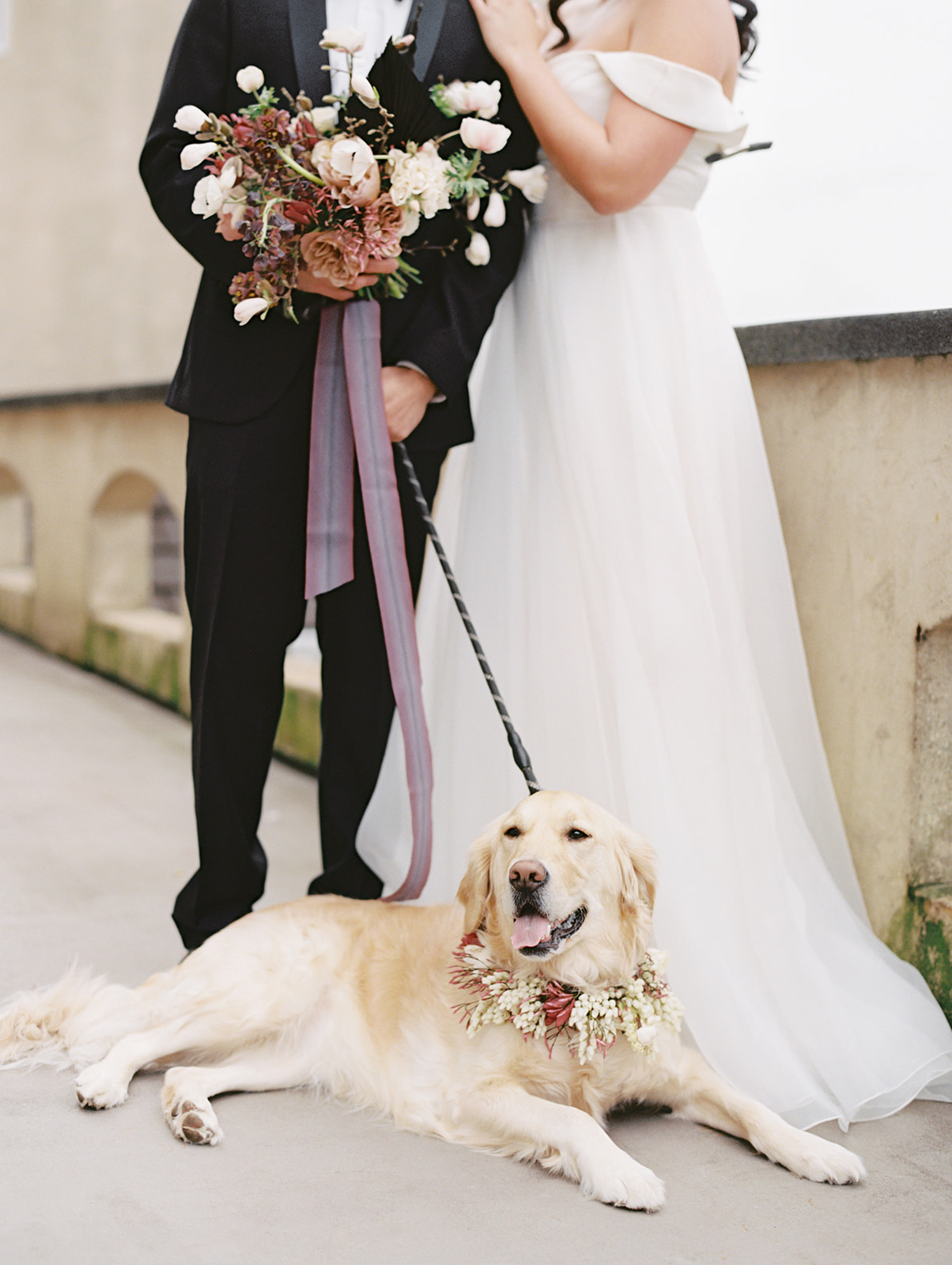 Chateau-Lill-Wedding-Couple-Standing-Holding-Bouquet-Dog-Laying.jpg The couple standing and holding bouquet on the balcony of Chateau Lill, with Belle the dog laying in front