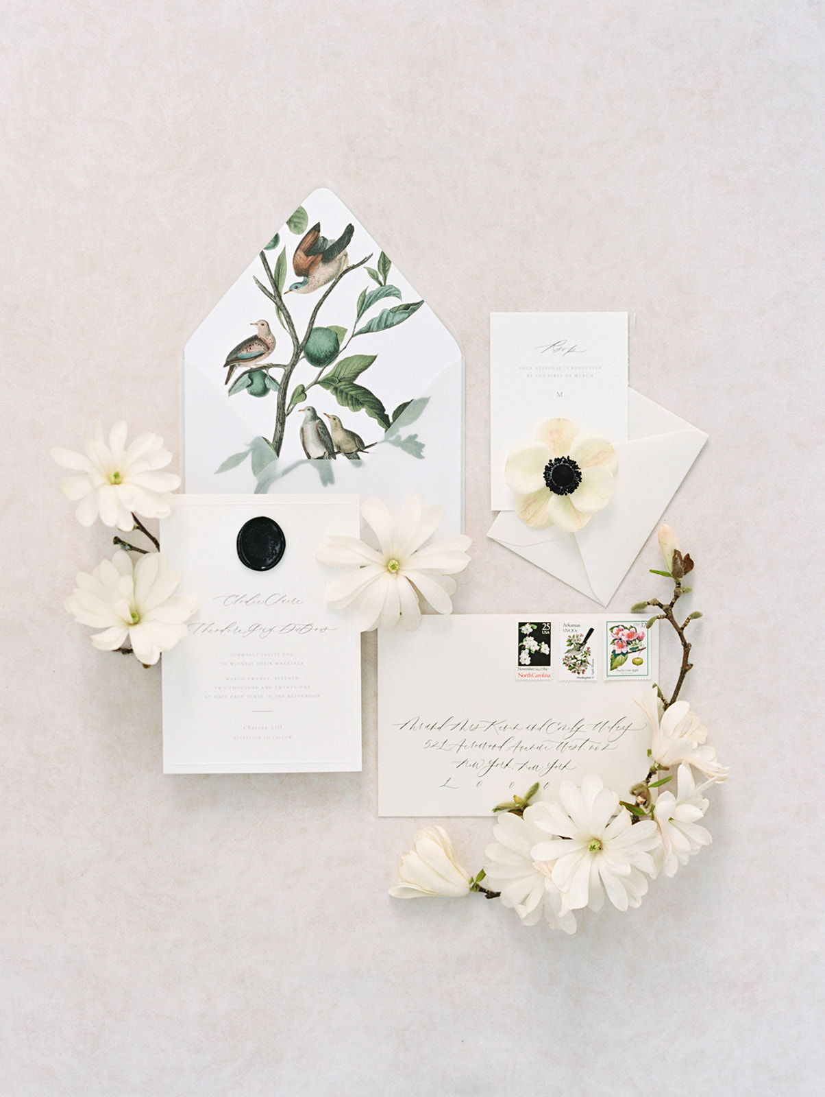 Chateau-Lill-Wedding-Stationery-Flatlay-Anenomes-Tulip-Magnolias.jpg Wedding invitation with anenomes and tulip magnolias on a white background