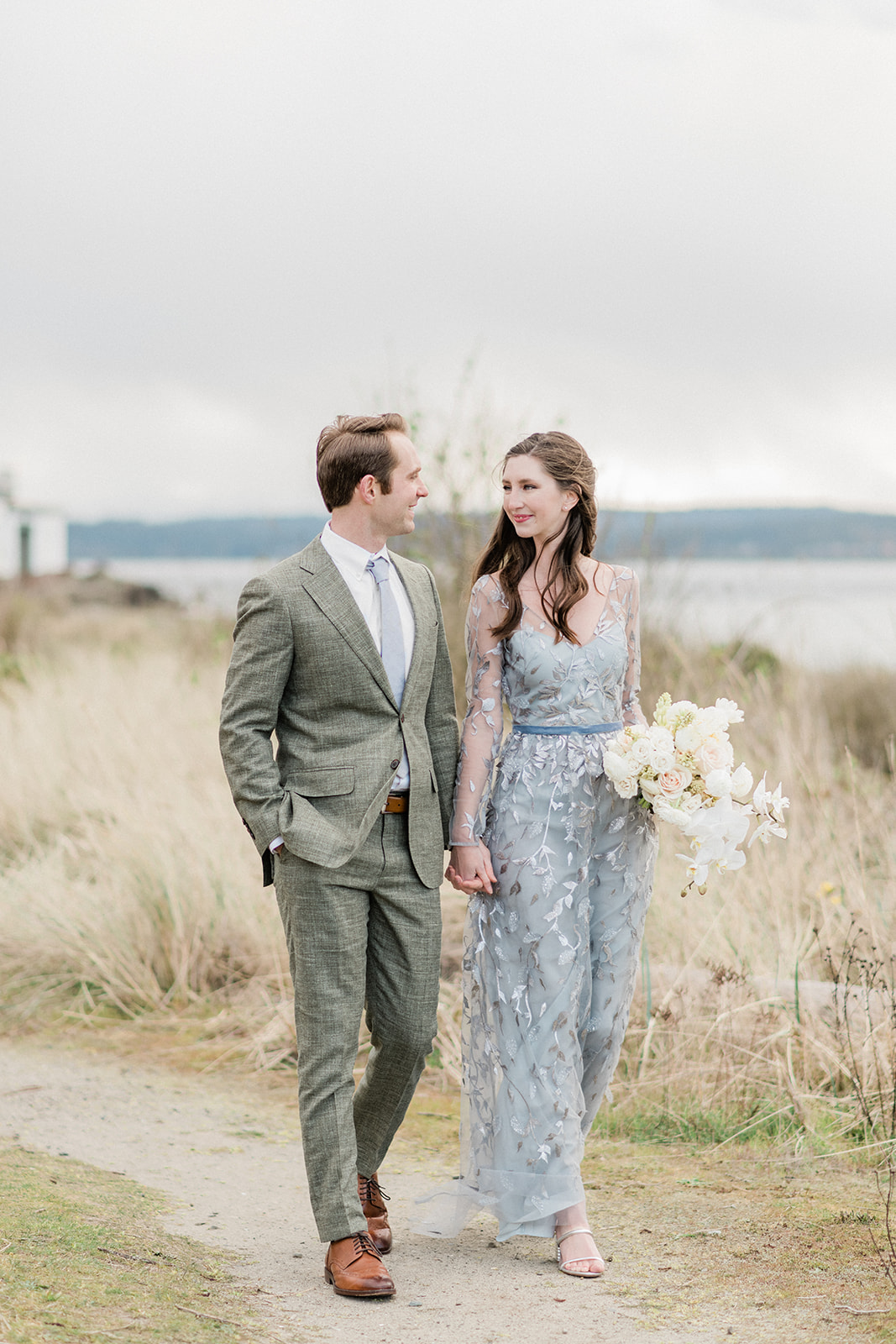 Discovery-Park-Elopement-Walking-In-Park.jpg Couple walking in park, holding hands