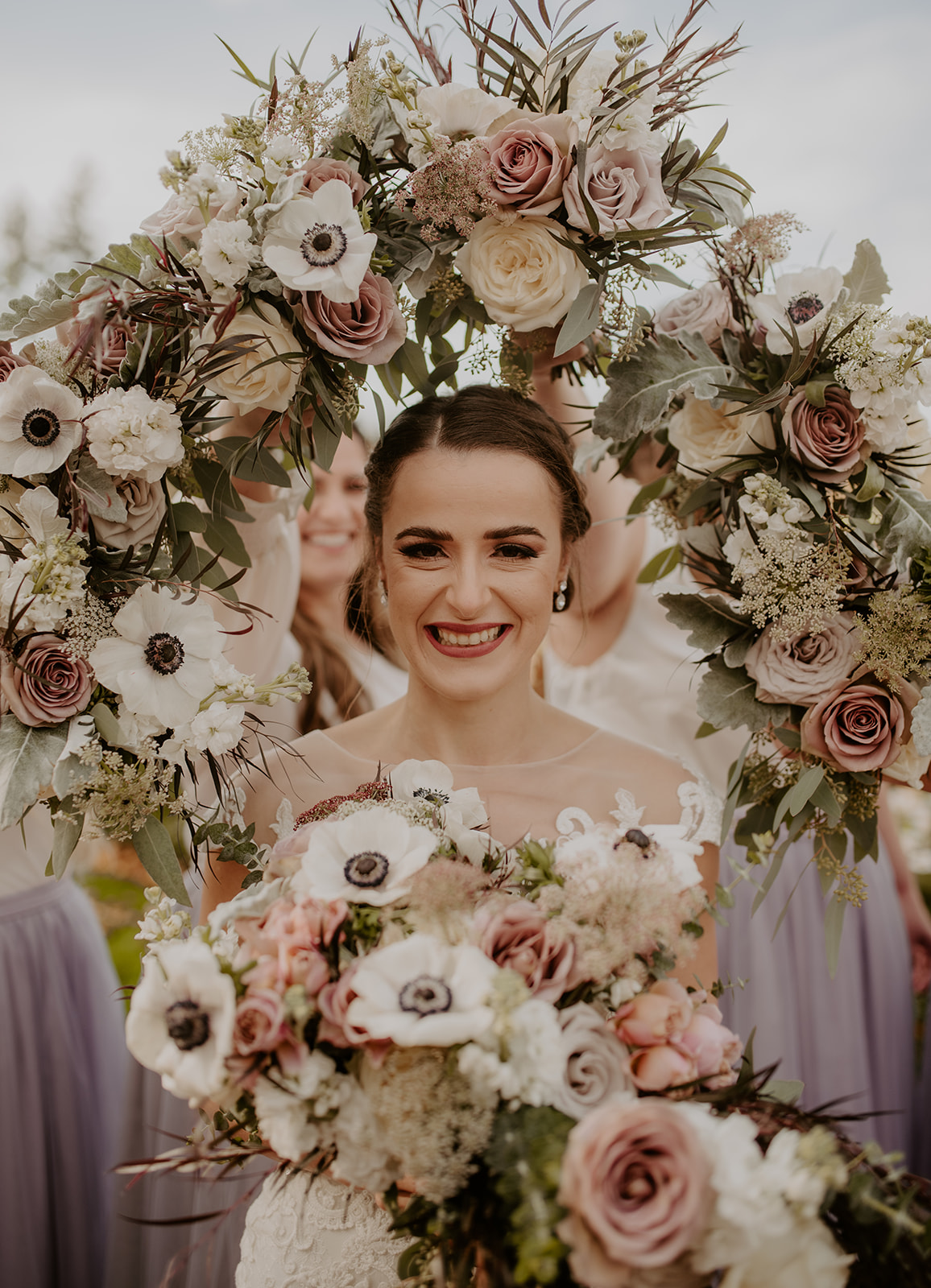 Kelley-Farm-Wedding-Flower-Halo.jpg The bridesmaids using their bouquets to create a flower halo around the bride