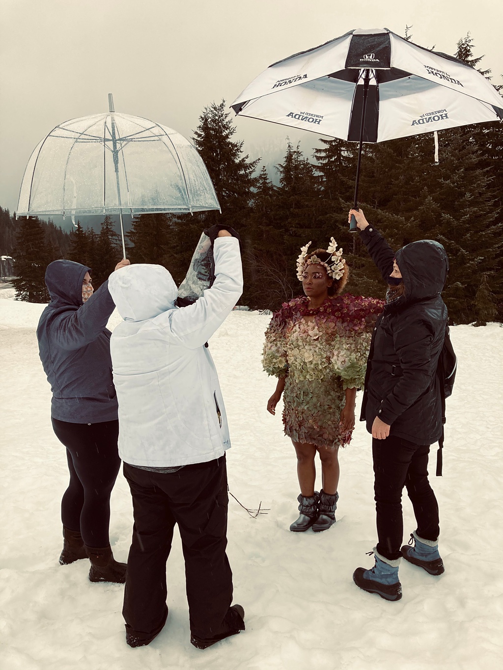 The team working together to protect Tasia from the freezing rain!