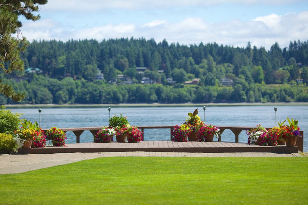 Folk Art Flowers Best Outdoor Wedding Venues in Seattle_0004 a lawn at Kiana Lodge with a view of the water and the island across the water