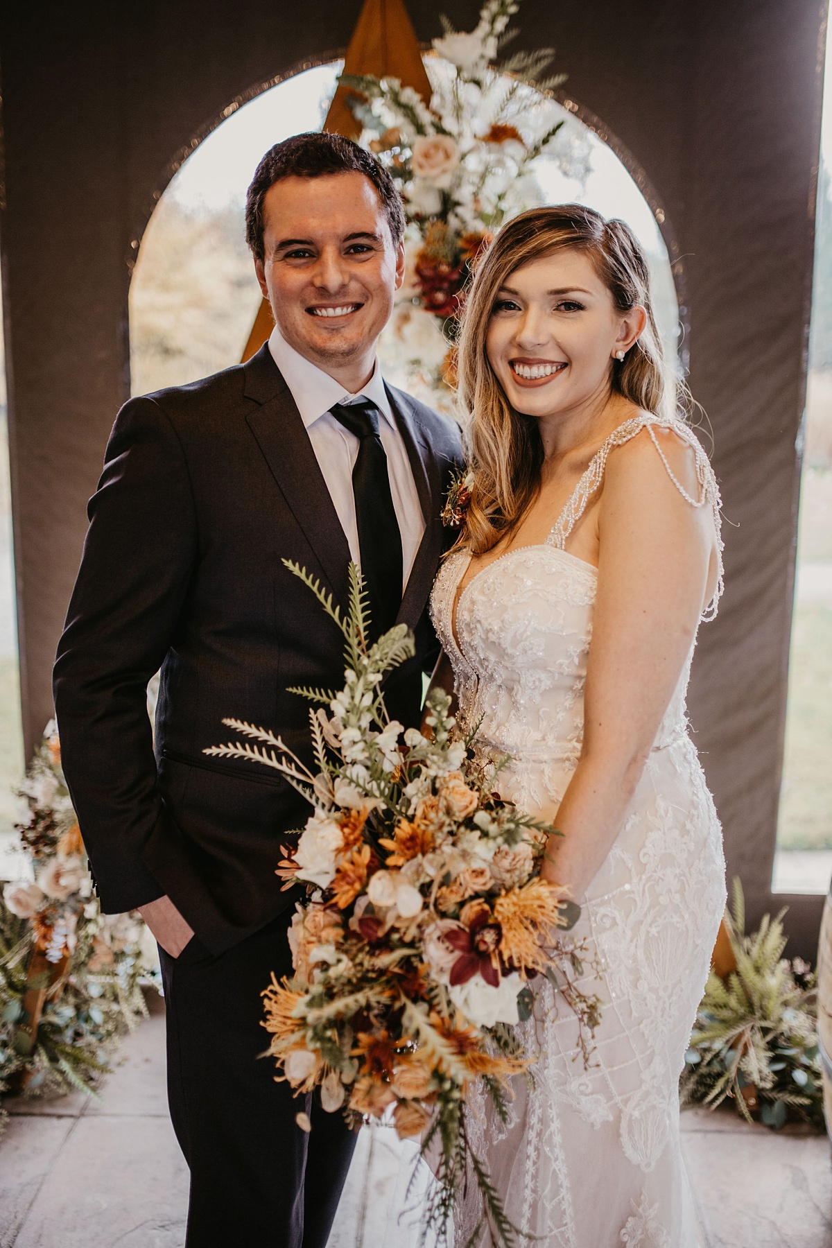 Willows-Lodge-Wedding-Fall-Bridal-Bouquet a bride and groom smiling as the bride holds her bridal bouquet