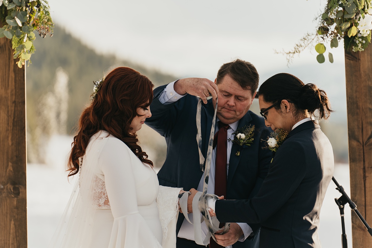 The botanical print hand-dyed silk ribbon being used in handfasting ceremony