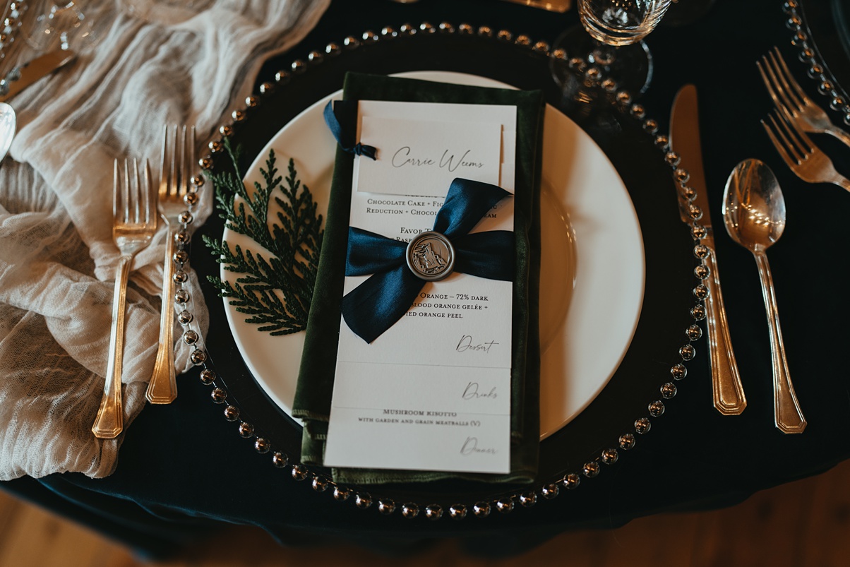 The hand-lettered menus on top of velvet green napkins