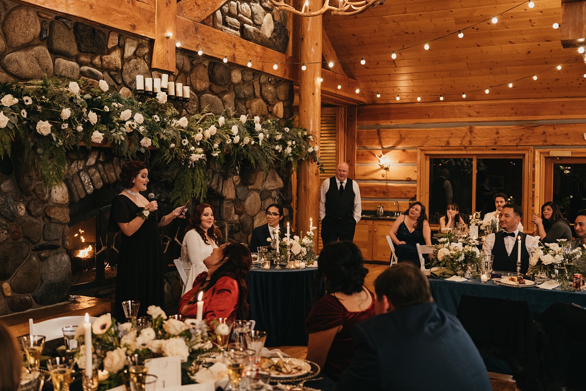 Wedding reception setup with focal point of the fireplace and mantle for speeches