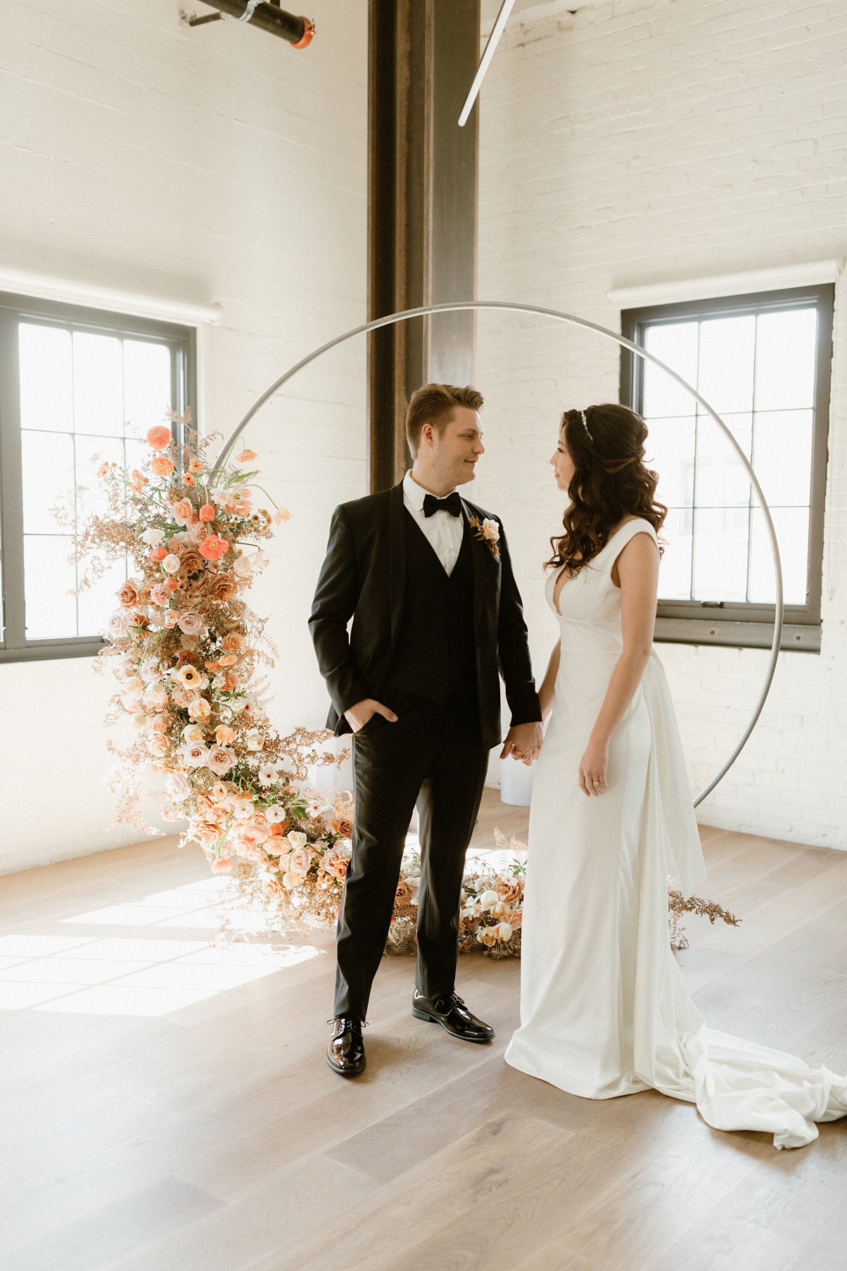 Block-41-Wedding-Ceremony-Arch-Floral Block 41 wedding ceremony arch florals with couple standing in front