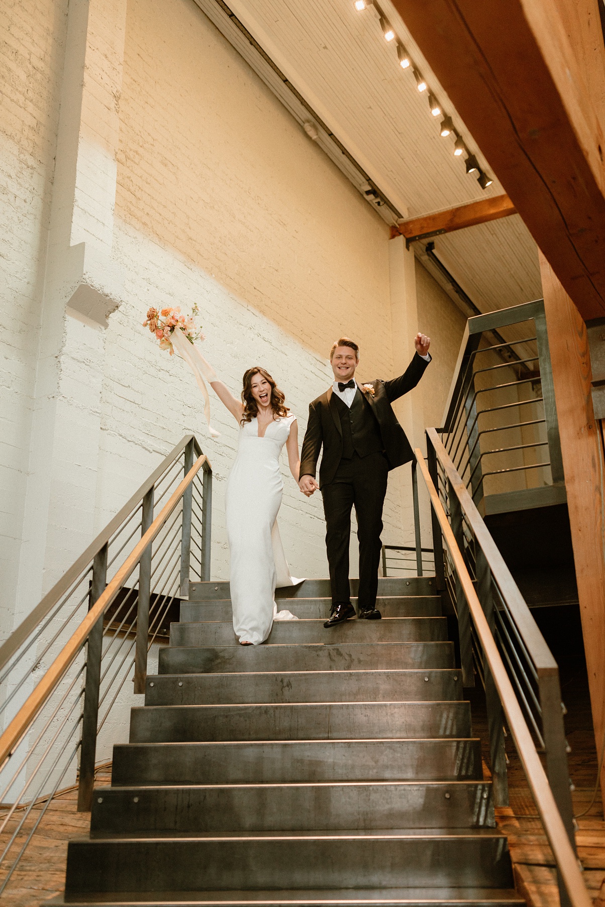 Block-41-Wedding-Reception Couple walking down stairs at Block 41 wedding reception