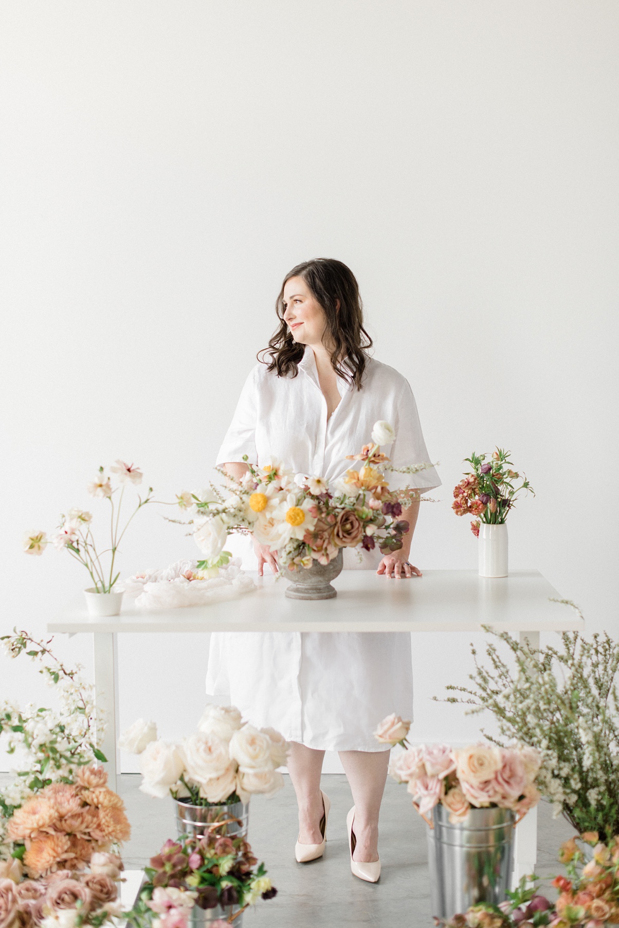owner Carolyn Kulb working at a table full of flowers