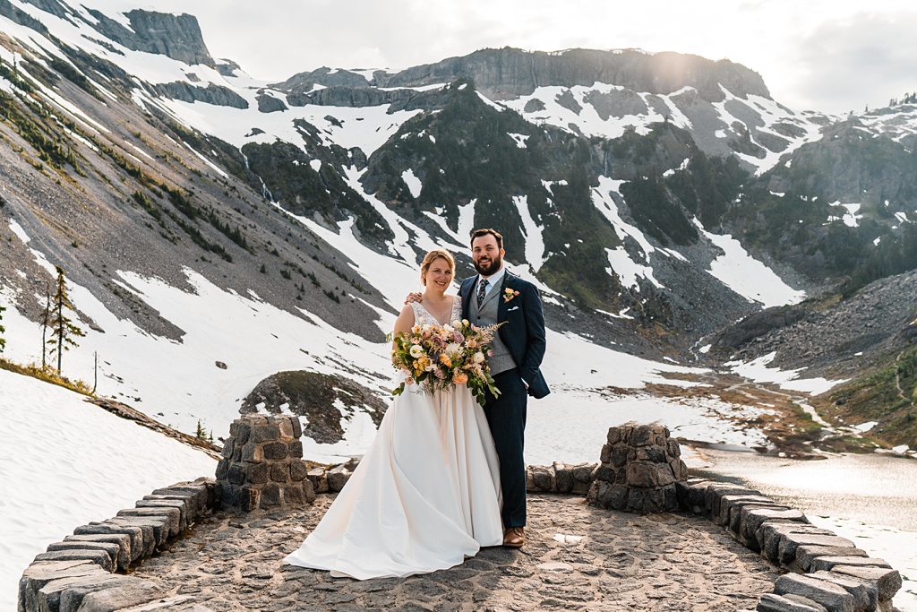 Mountain-Wedding-with-Vibrant-Summer-Blooms-Just-Married-Couple The just-married couple pose for a photo, holding the bouquet