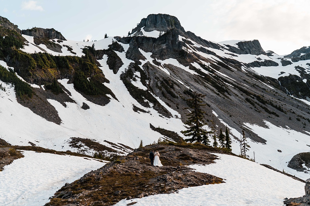 Mountain-Wedding-with-Vibrant-Summer-Blooms-Snowfields-With-Couple The snowfields on the mountain