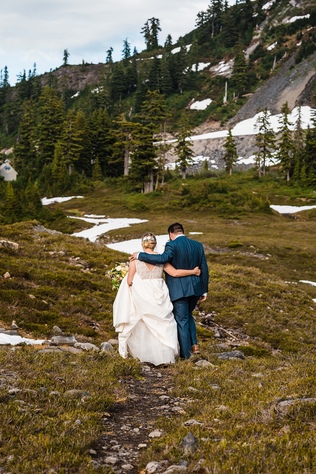 Mountain-Wedding-with-Vibrant-Summer-Blooms-Walking-Back The couple walking back from the mountain
