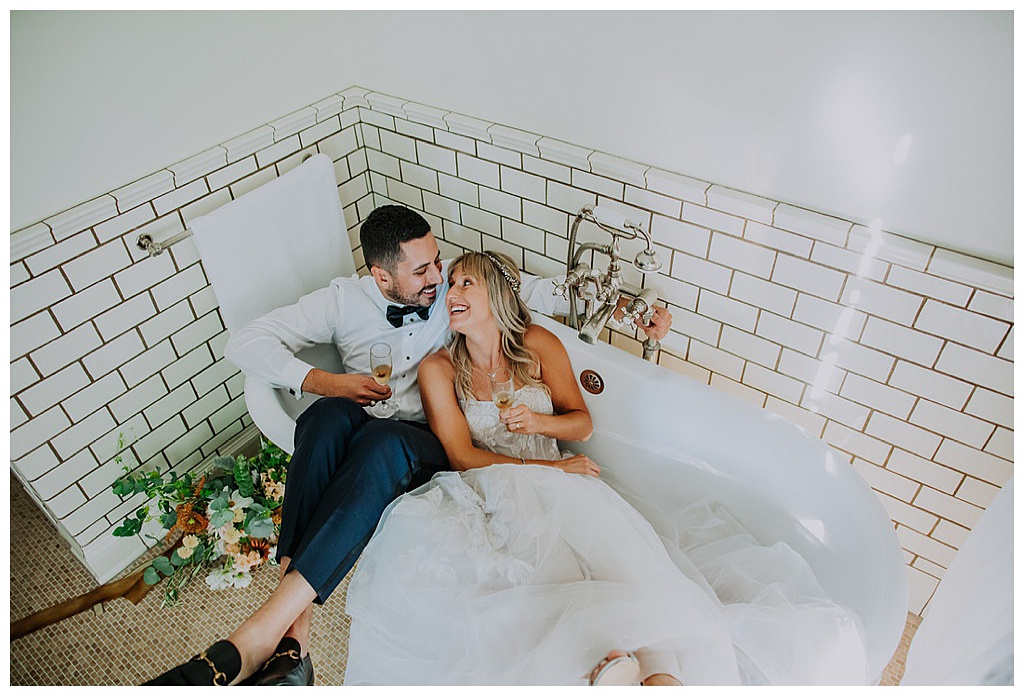 Seattle-Wedding-Florist-Bloom-Poet-Fall-Wedding-Boho-Flowers-Bathtub The couple sits in a bathtub with champagne