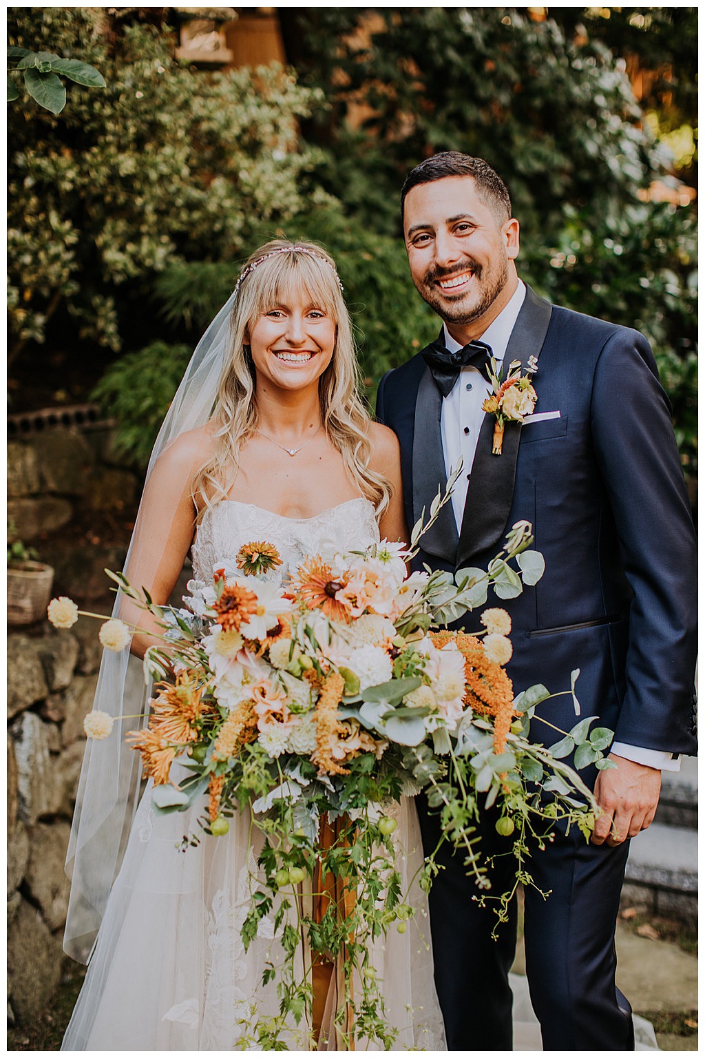 Seattle-Wedding-Florist-Bloom-Poet-Fall-Wedding-Boho-Flowers-Cascading-Bouquet The couple smiling and holding the cascading bouquet
