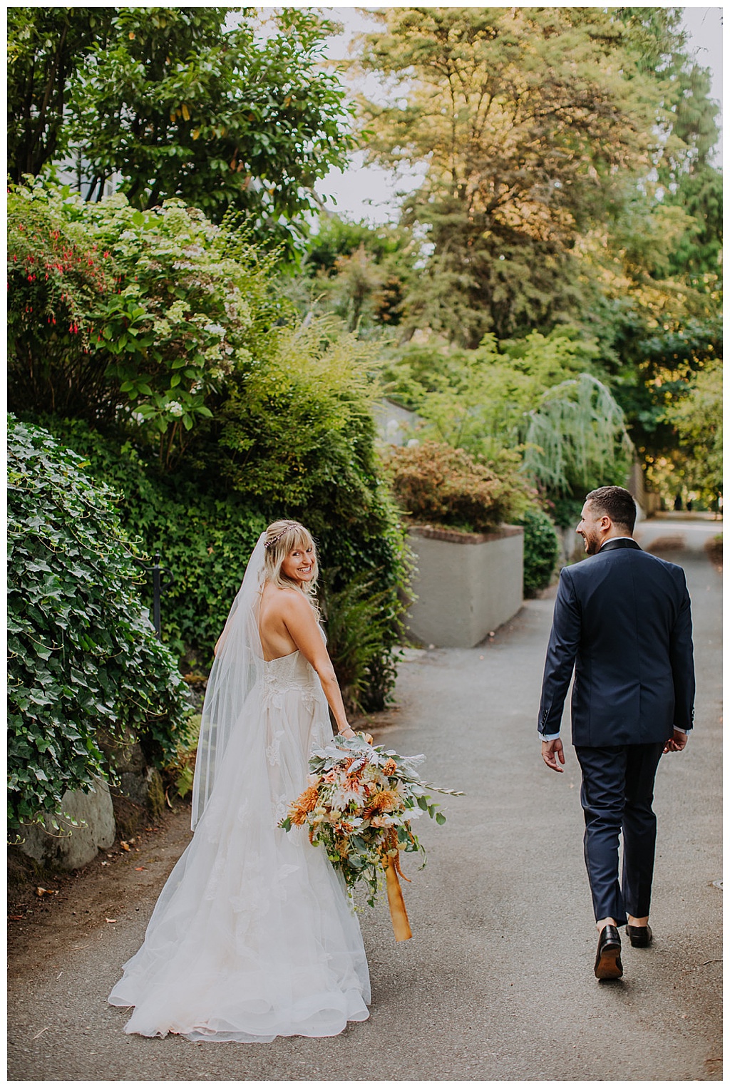 Seattle-Wedding-Florist-Bloom-Poet-Fall-Wedding-Boho-Flowers-Couple-Walking The couple walking holding the fall bridal bouquet