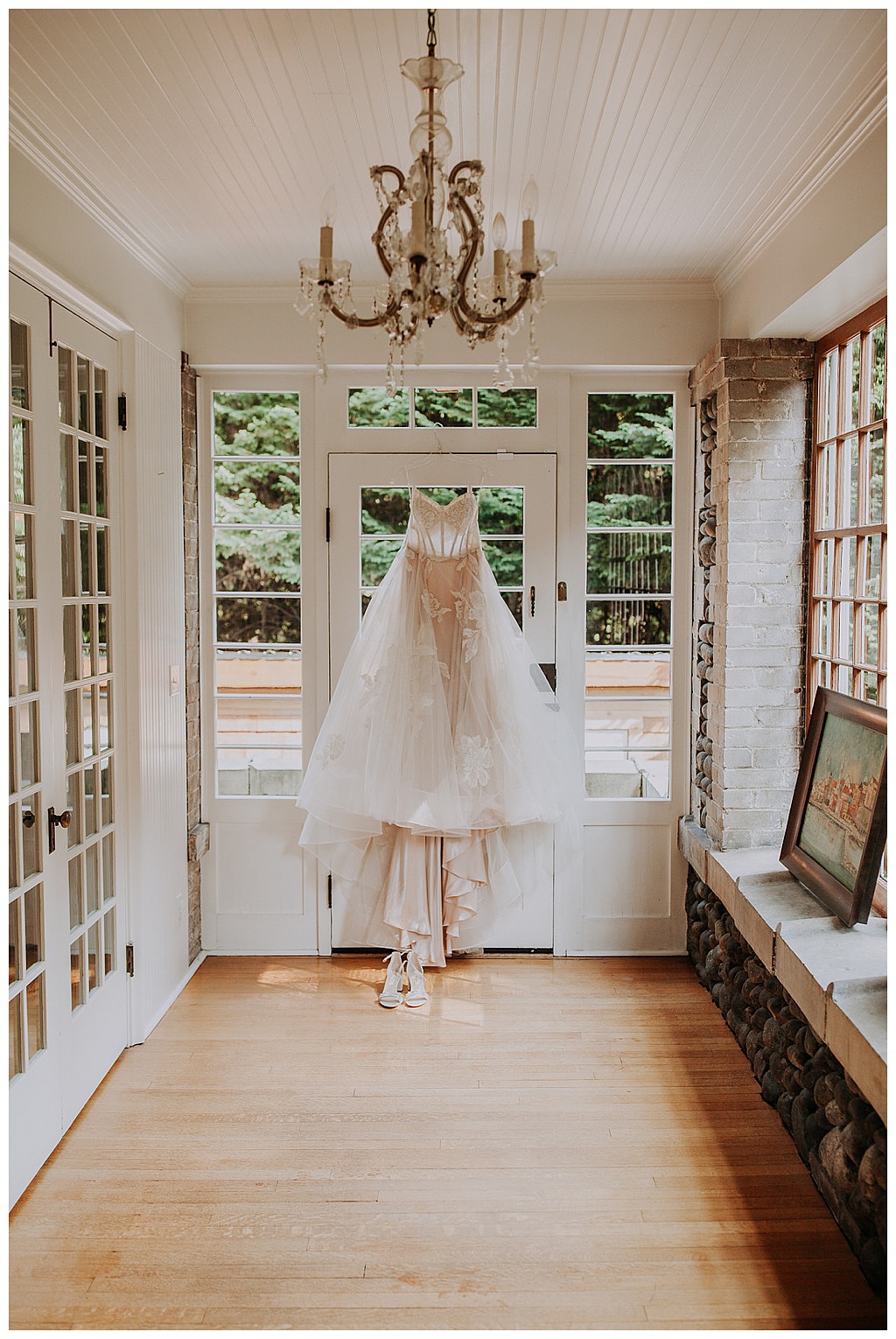 Seattle-Wedding-Florist-Bloom-Poet-Fall-Wedding-Boho-Flowers-Wedding-Dress the bride's wedding dress hangs from a doorway