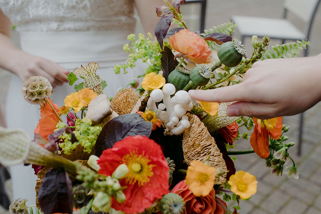 Bloom-Poet-Seattle-Wedding-Florist-Kiana-Lodge-Wedding-Bouquet-Mushrooms Someone touching the mushrooms in the bridal bouquet