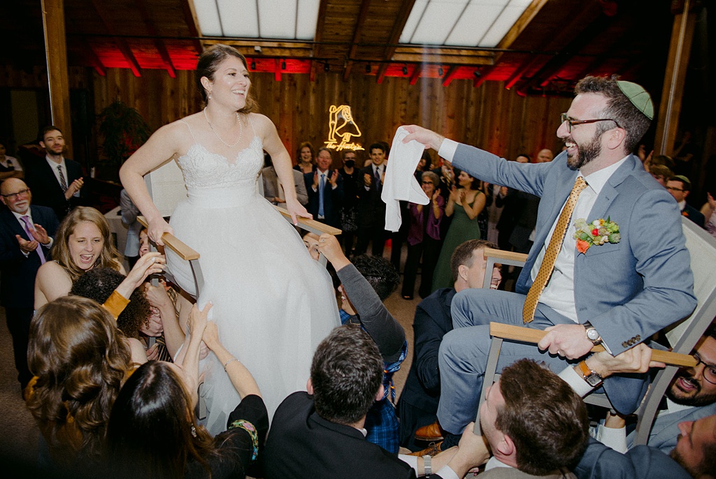 Bloom-Poet-Seattle-Wedding-Florist-Kiana-Lodge-Wedding-Hora-Dance The bride and groom lifted in chairs for the hora