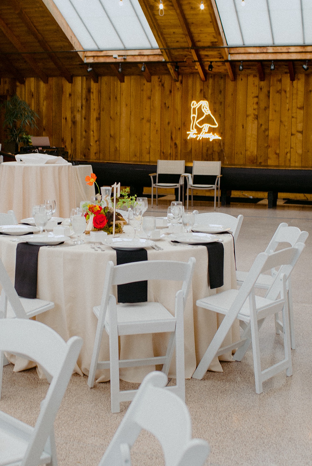 Bloom-Poet-Seattle-Wedding-Florist-Kiana-Lodge-Wedding-Reception The indoor part of the lodge set up with neon sign and florals