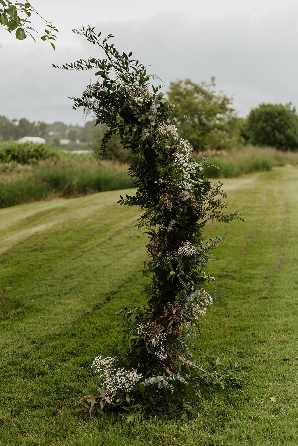 A closer look at the textured floral arch for the wedding ceremony