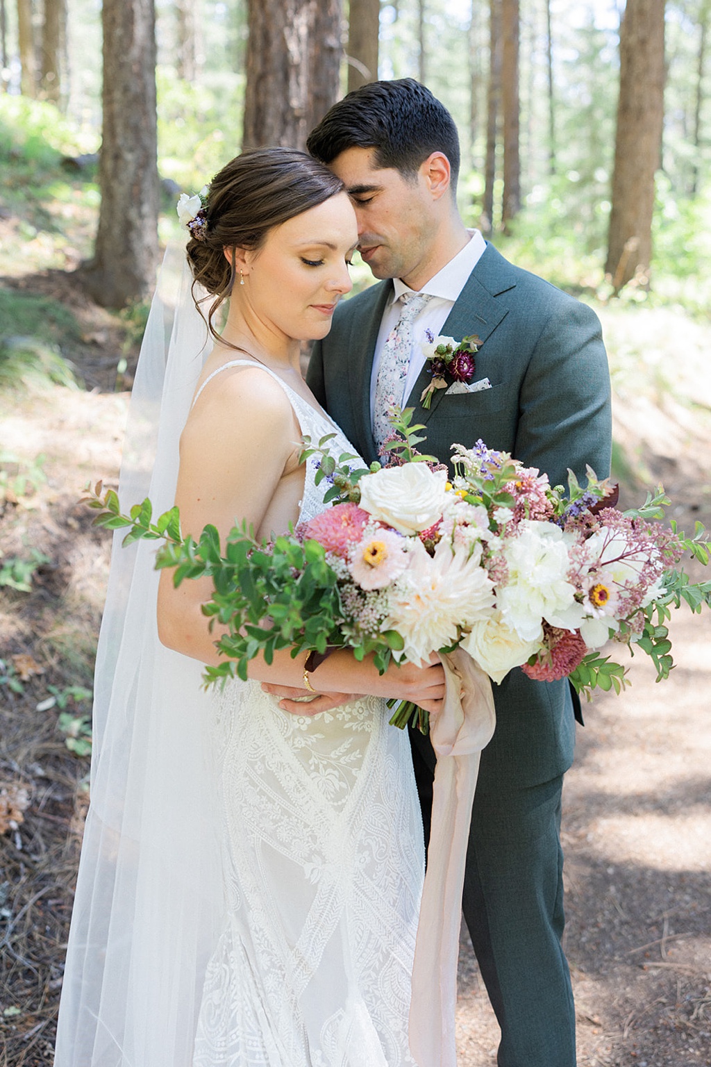 Bloom-Poet-Seattle-Wedding-Florist-Tierra-Retreat-Center-Forest-Wedding The bride and groom hold a bouquet in the forest for their Tierra Retreat Center wedding