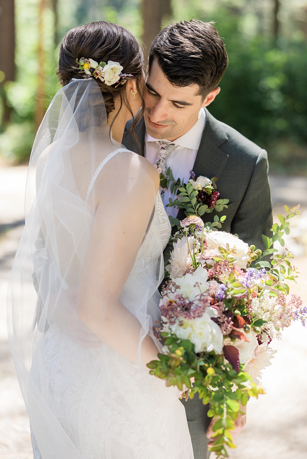 Bloom-Poet-Seattle-Wedding-Florist-Tierra-Retreat-Center-Wedding-Hair-Flowers The bride and groom embrace, showing off her hair flowers