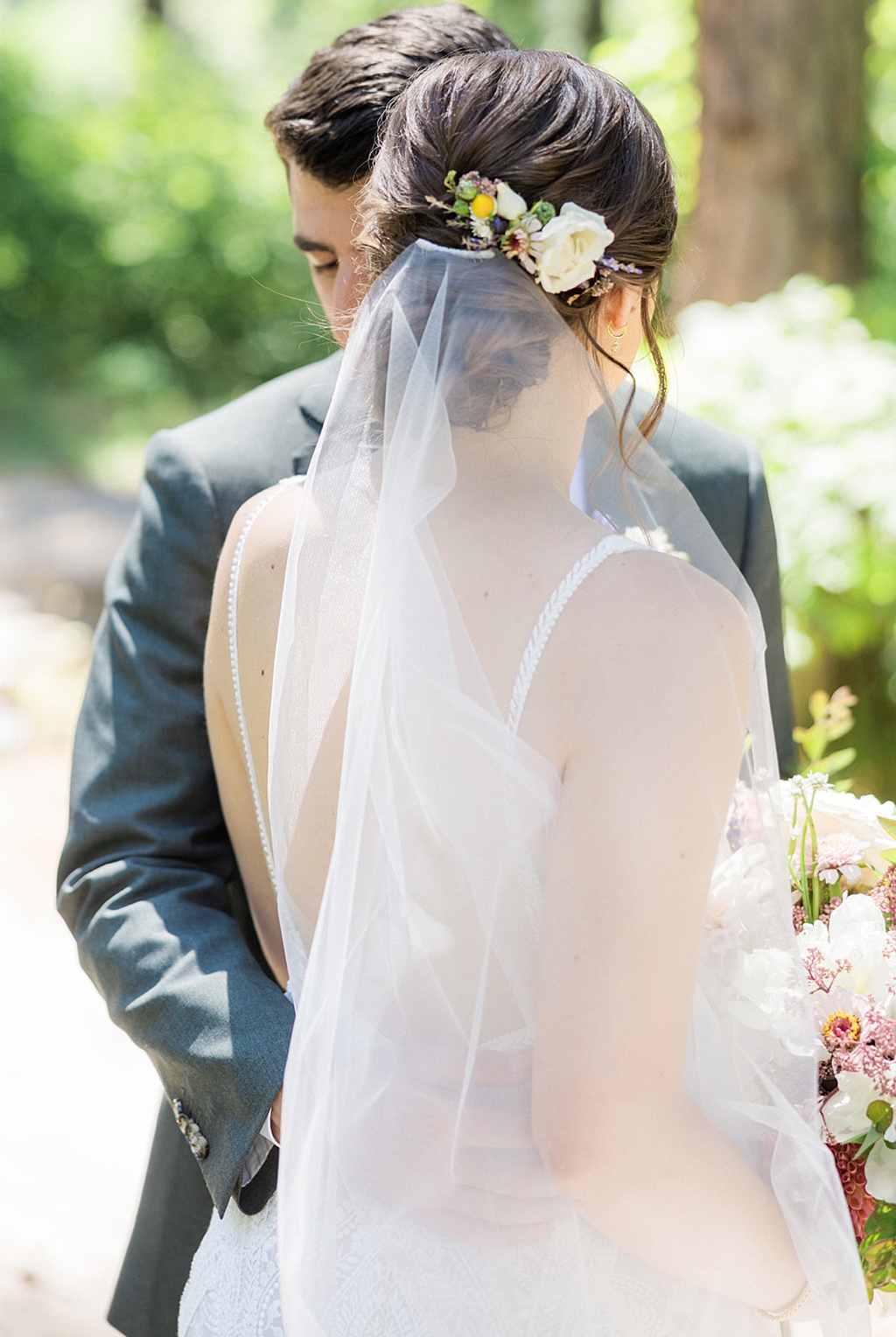 Bloom-Poet-Seattle-Wedding-Florist-Tierra-Retreat-Center-Wedding-Veil-Hair-Flowers The bride and groom embrace, showing off her veil and hair flowers