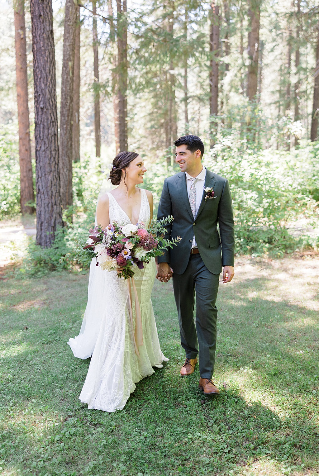Bloom-Poet-Seattle-Wedding-Florist-Tierra-Retreat-Center-Wedding-in-Woods The bride and groom walk through the woods at this Tierra Retreat Center wedding