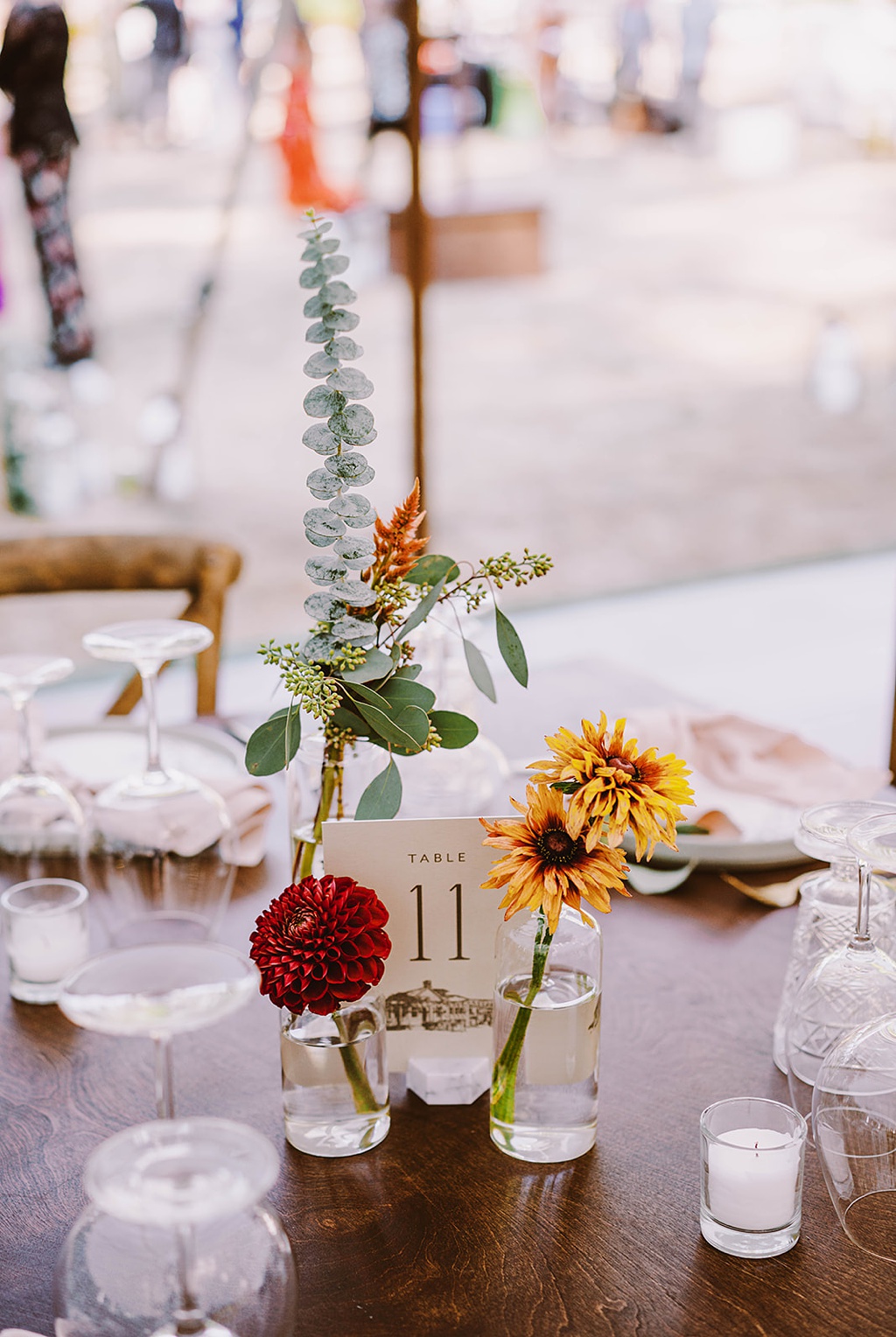 Bloom-Poet-Seattle-Wedding-Florist-Summer-Wedding-Bud-Vases.jpg A table is set with bud vases, glassware, and candles for this summer wedding