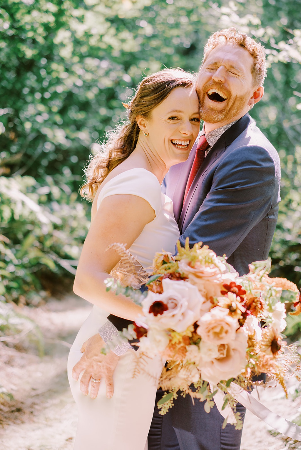 Bloom-Poet-Seattle-Wedding-Florist-Summer-Wedding-Portrait.jpg The couple laughing and holding a summer wedding flower bouquet