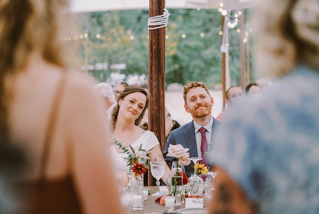 Bloom-Poet-Seattle-Wedding-Florist-Summer-Wedding-Reception-Head-Table.jpg The head table with couple smiling at this summer wedding